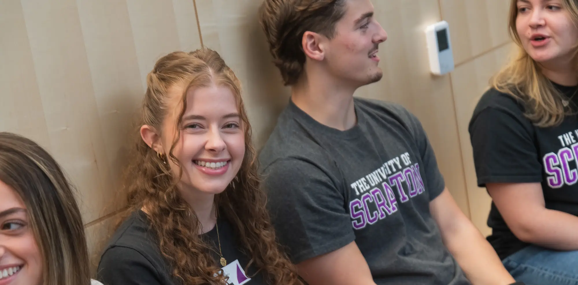 A group of Scranton college students sitting indoors