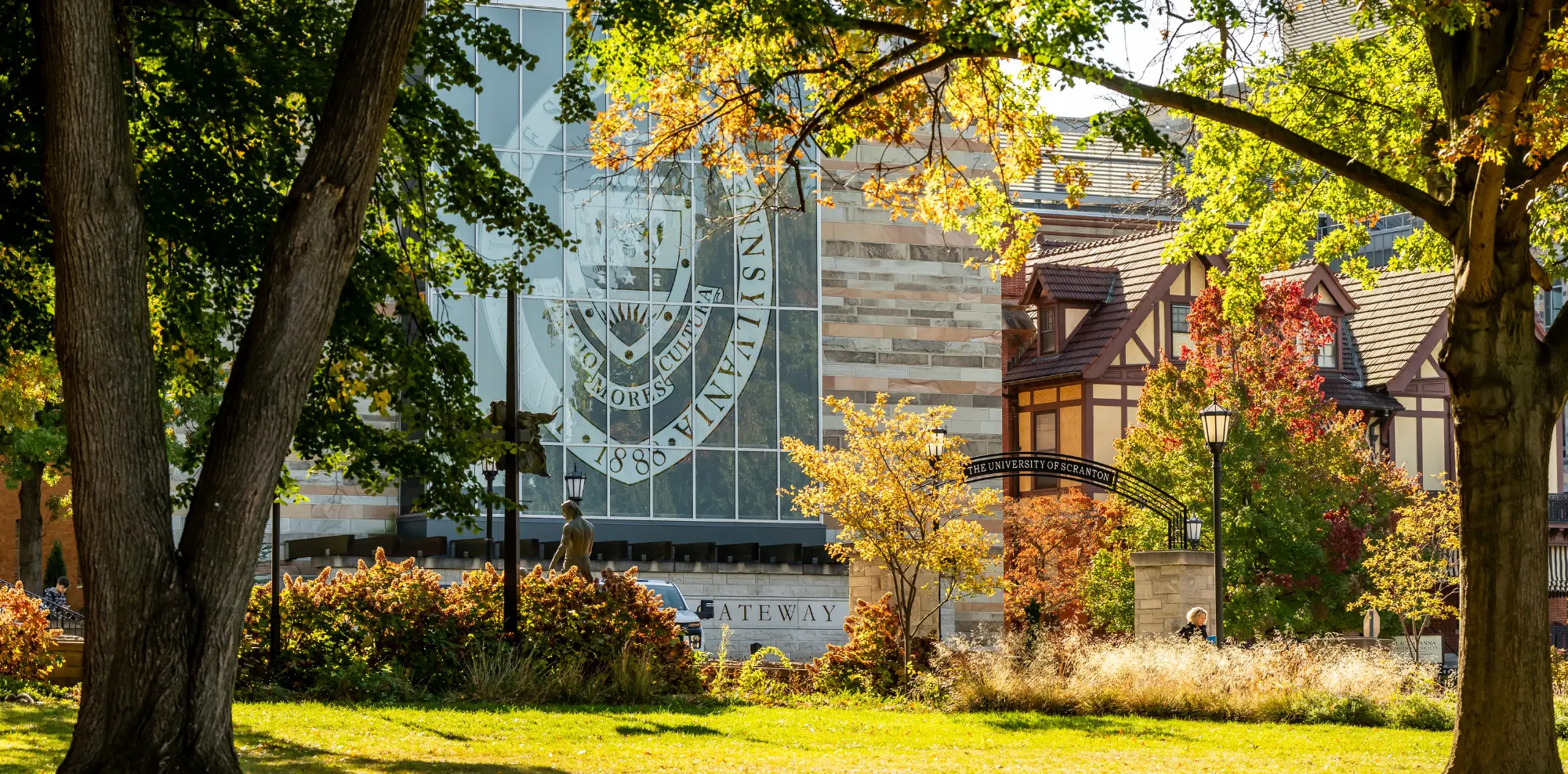 Fall trees frame a sunny University of Scranton campus